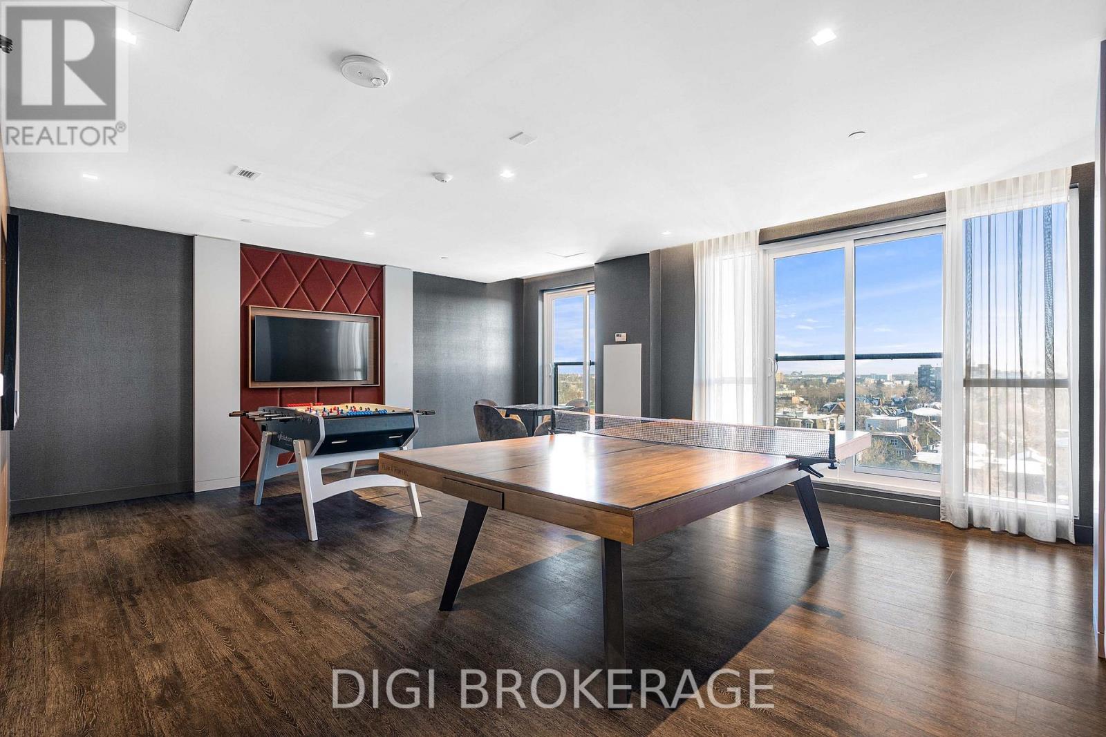 A modern living room with a pool table and a view of the city.