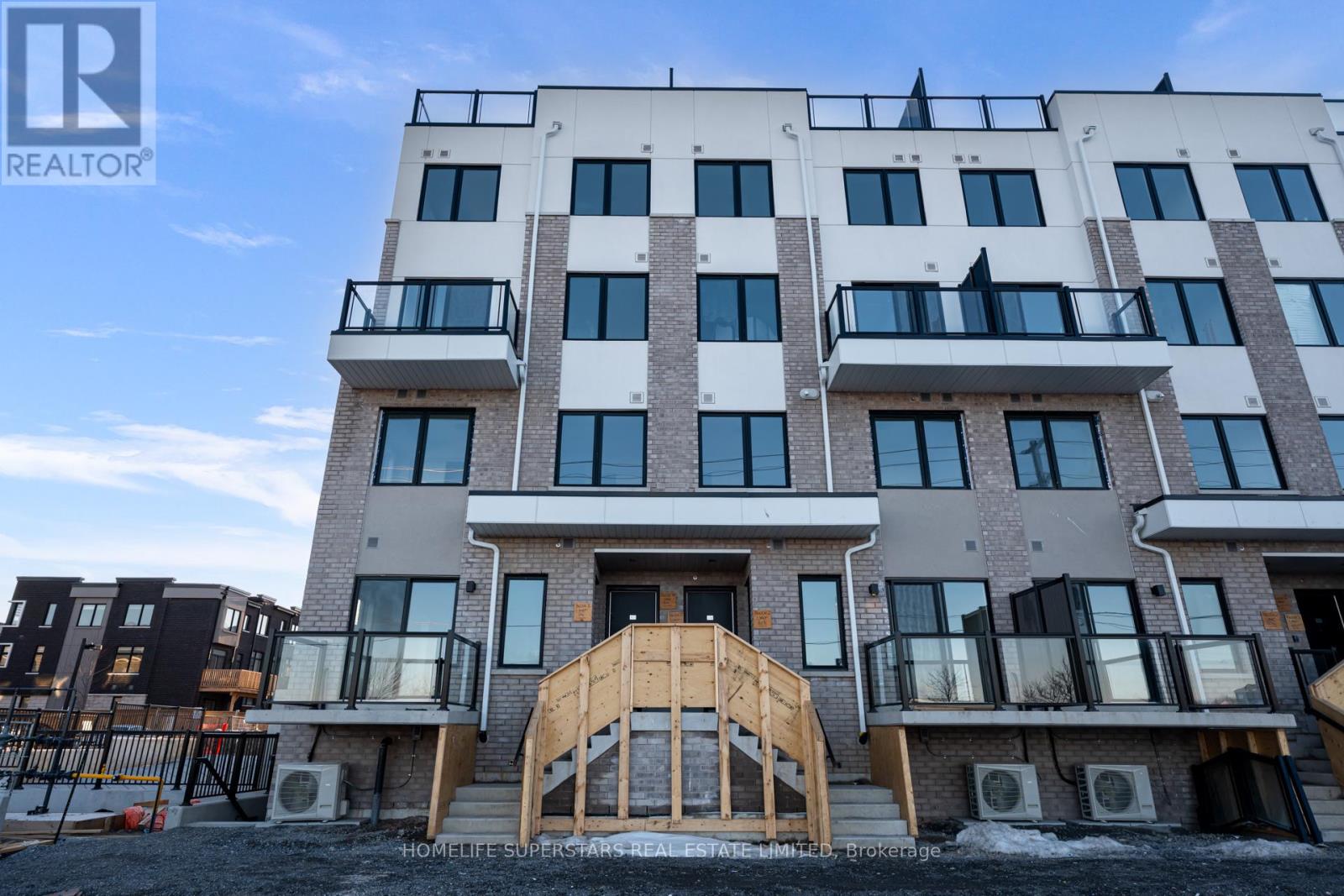 A multi-story residential building with a balcony on the second floor.
