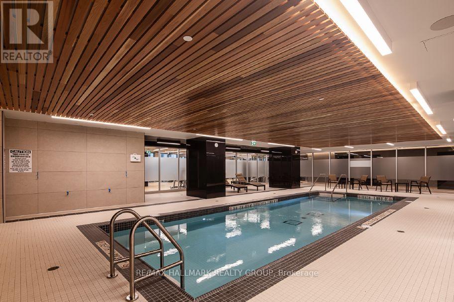 A large indoor swimming pool with a wooden ceiling.