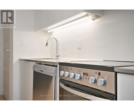 A kitchen with a stove top oven and a dishwasher.