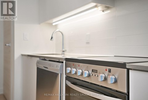 A kitchen with a stove top oven and a dishwasher.