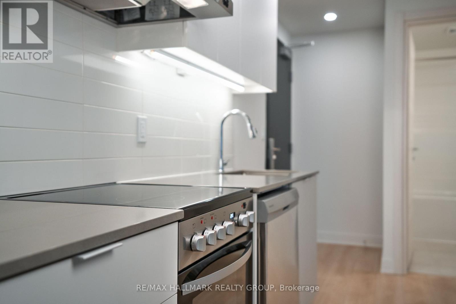 A modern kitchen with a stainless steel oven and sink.