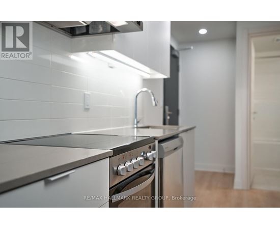 A modern kitchen with a stainless steel oven and sink.