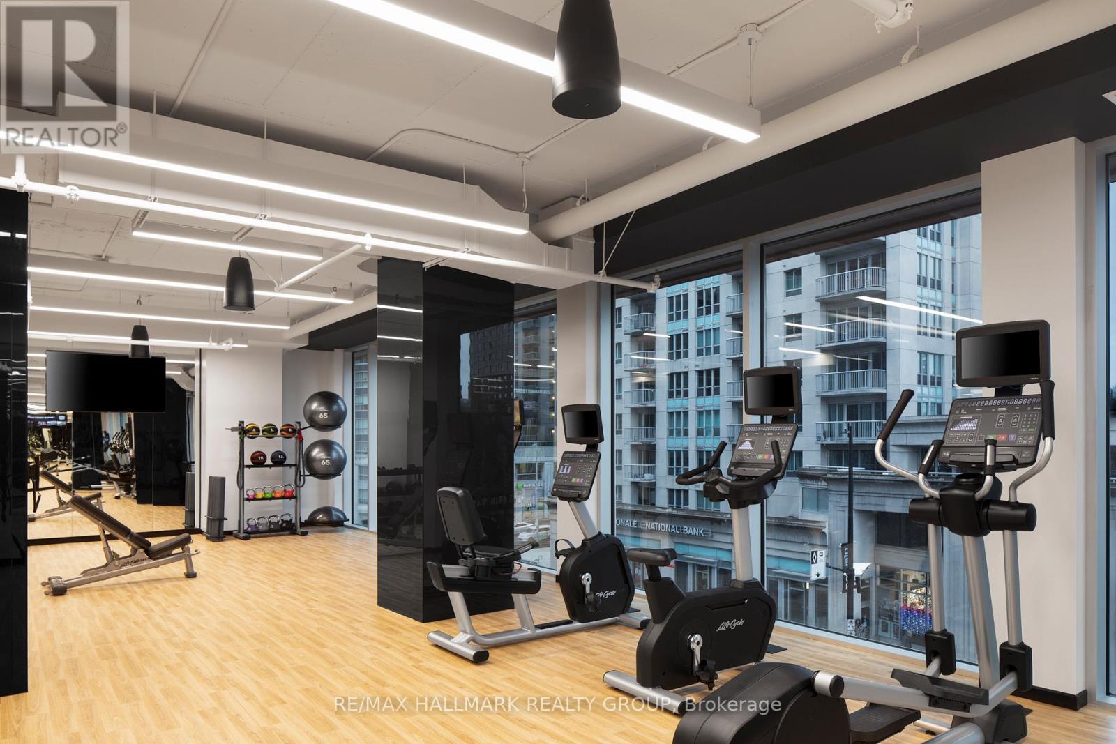 A gym with a view of the city outside the window.