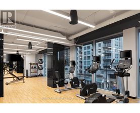 A gym with a view of the city outside the window.