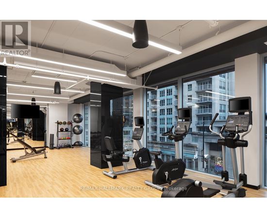 A gym with a view of the city outside the window.