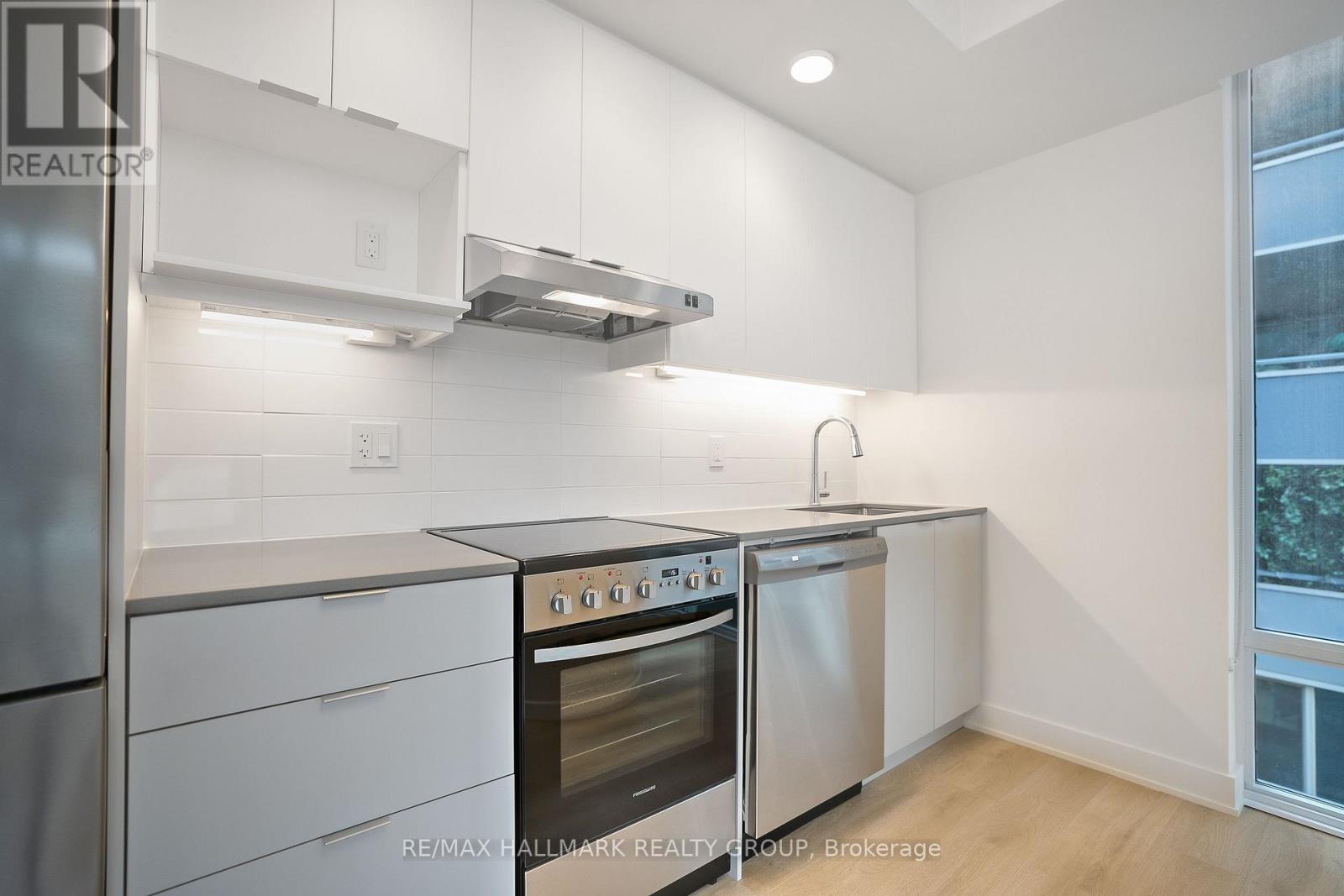 A kitchen with white cabinets and stainless steel appliances.