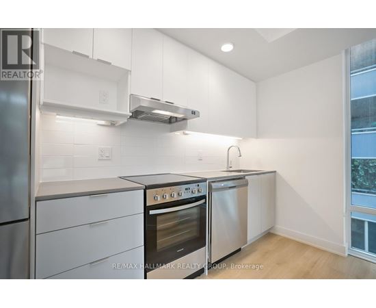 A kitchen with white cabinets and stainless steel appliances.