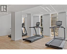 A gym with treadmills and a RE/MAX logo.