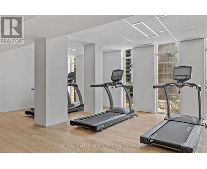 A gym with treadmills and a RE/MAX logo.