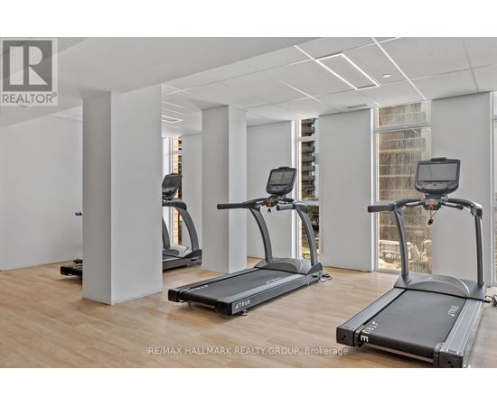 A gym with treadmills and a RE/MAX logo.