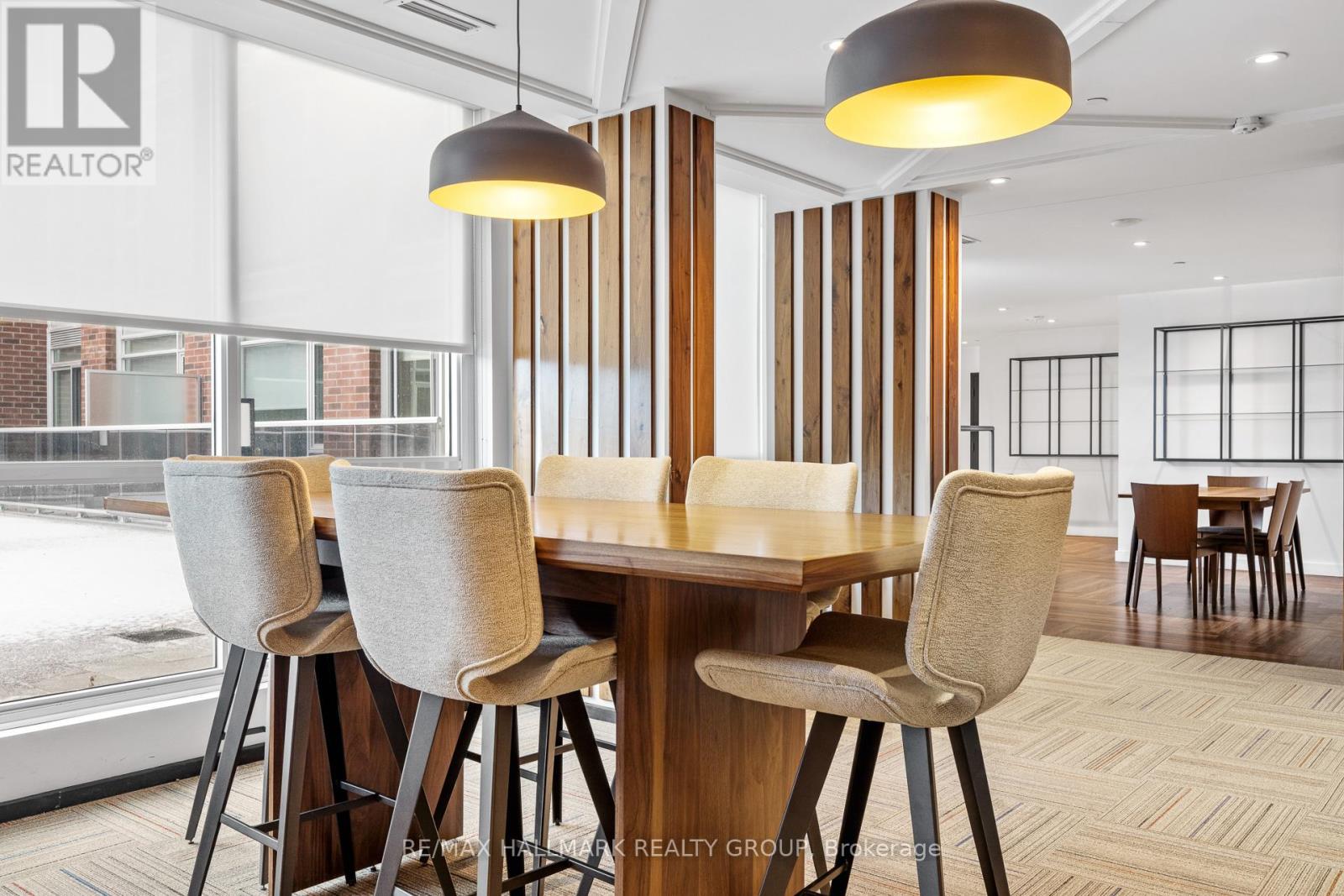 A dining room with a table and chairs.