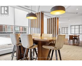 A dining room with a table and chairs.