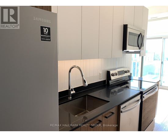 A kitchen with a Samsung fridge and a microwave oven.