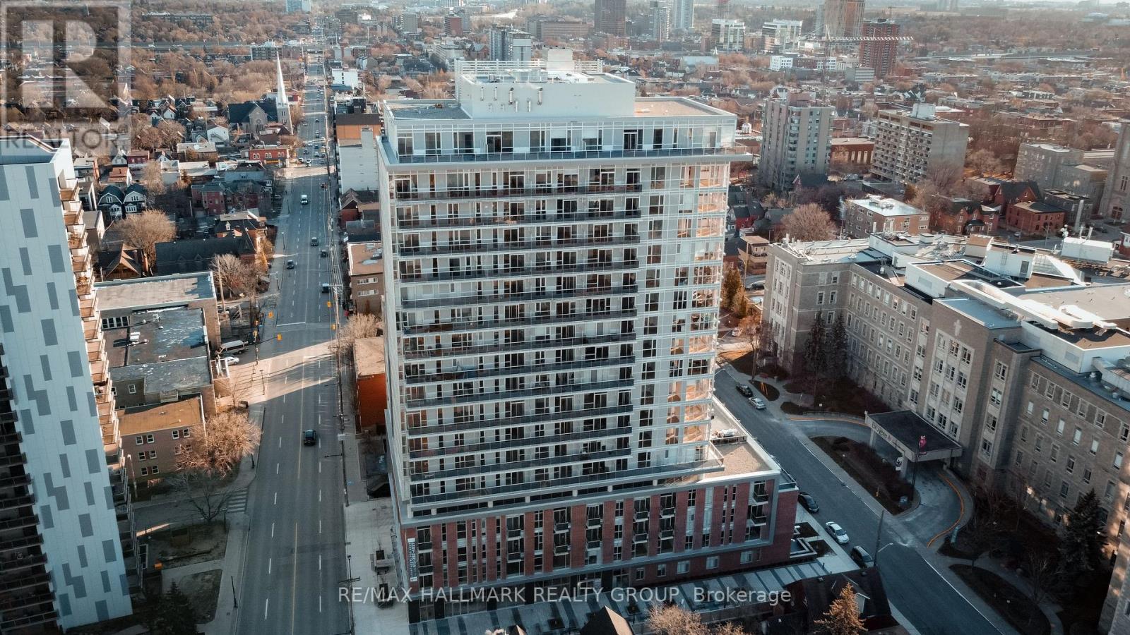 A tall building with a lot of windows is in the center of the image.
