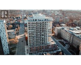 A tall building with a lot of windows is in the center of the image.