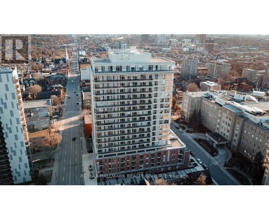A tall building with a lot of windows is in the center of the image.