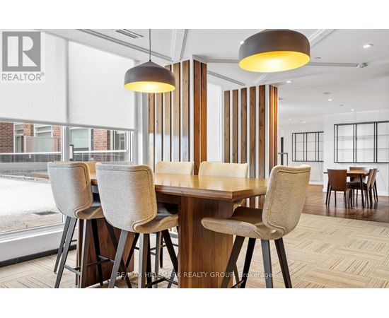 A dining room with a table and chairs.