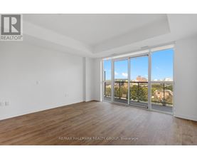 A spacious room with a view of the city through large windows.