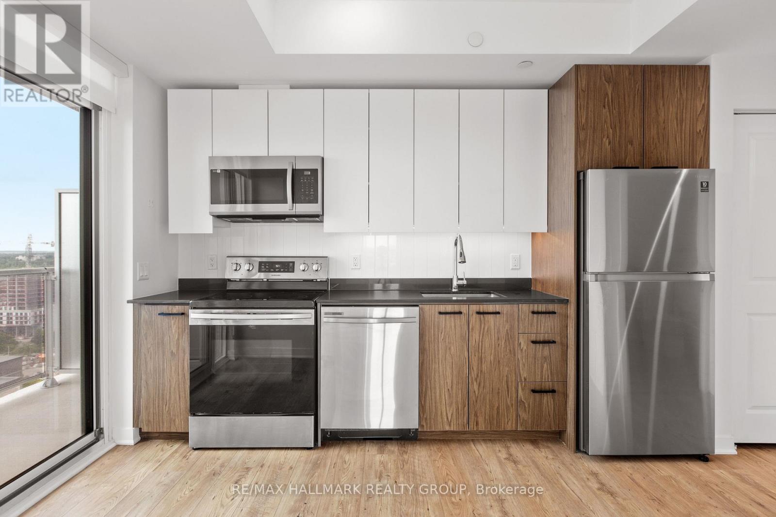 A modern kitchen with stainless steel appliances and wooden accents.
