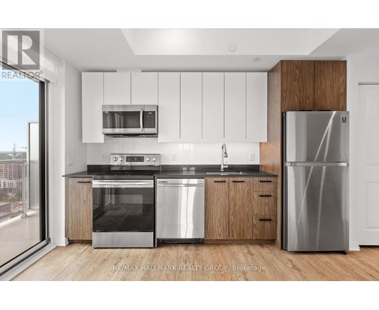 A modern kitchen with stainless steel appliances and wooden accents.