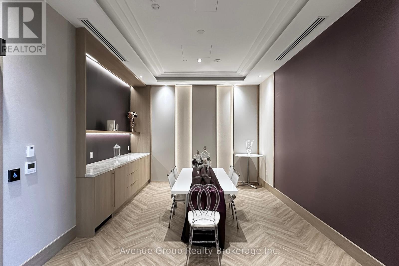 A well-lit, modern dining area with a long table set for six.