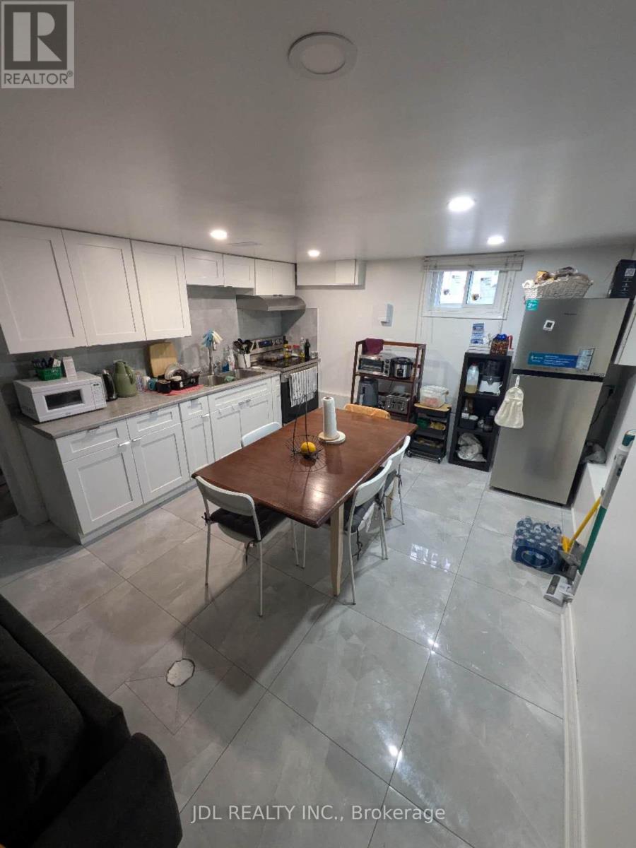A kitchen with a table and chairs in the middle of the room.