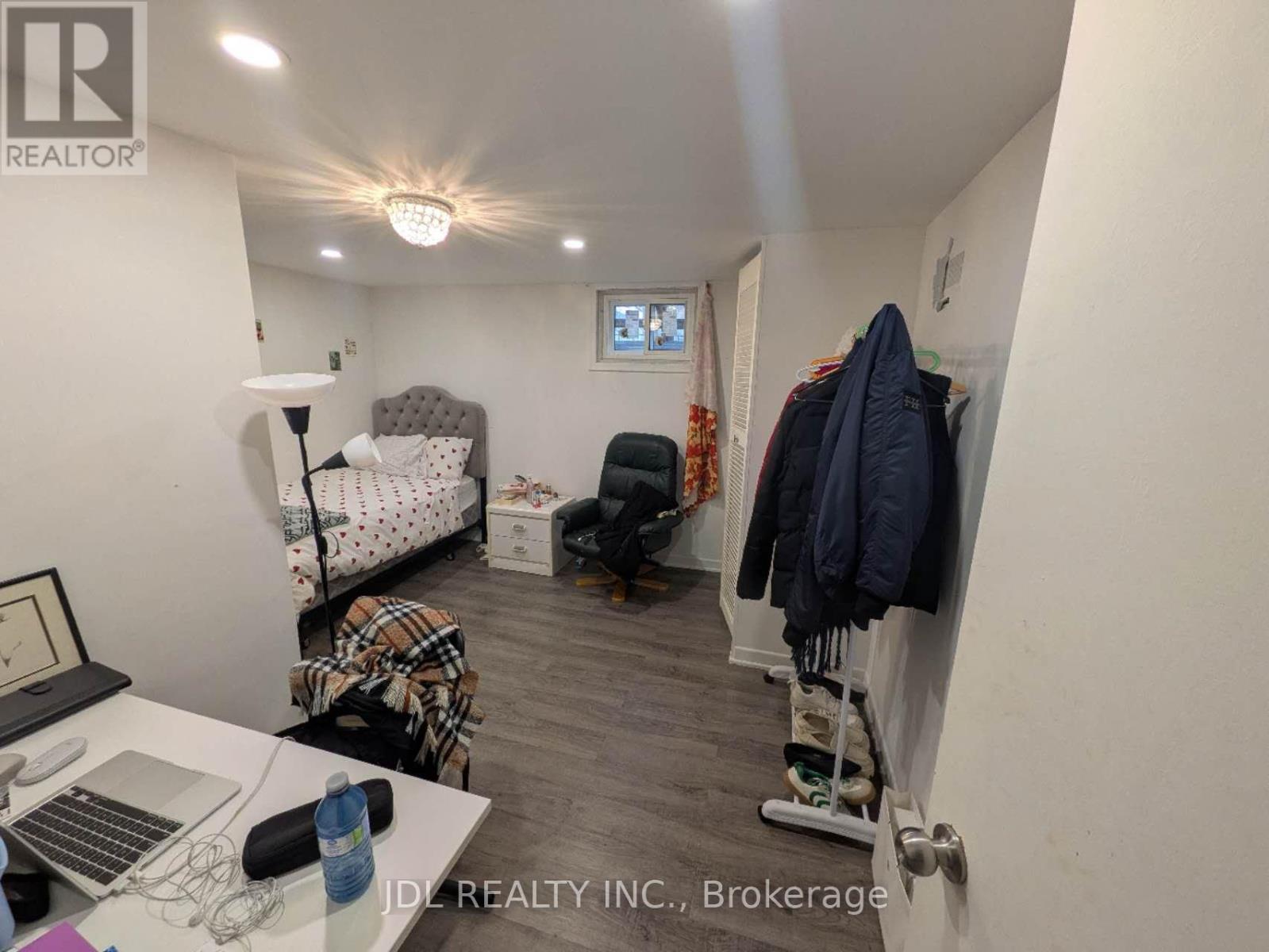 A room with a bed, desk, and chair.