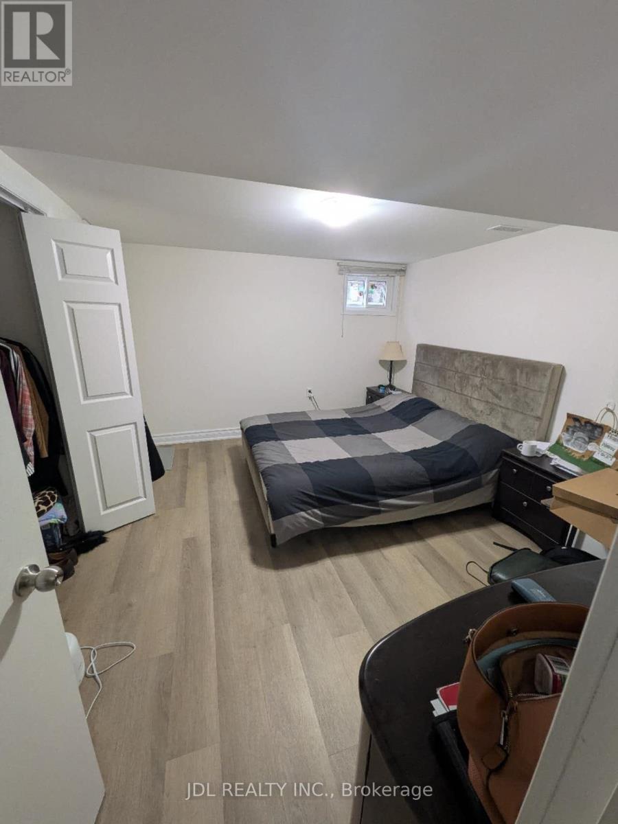 A bedroom with a bed, desk, and chair.