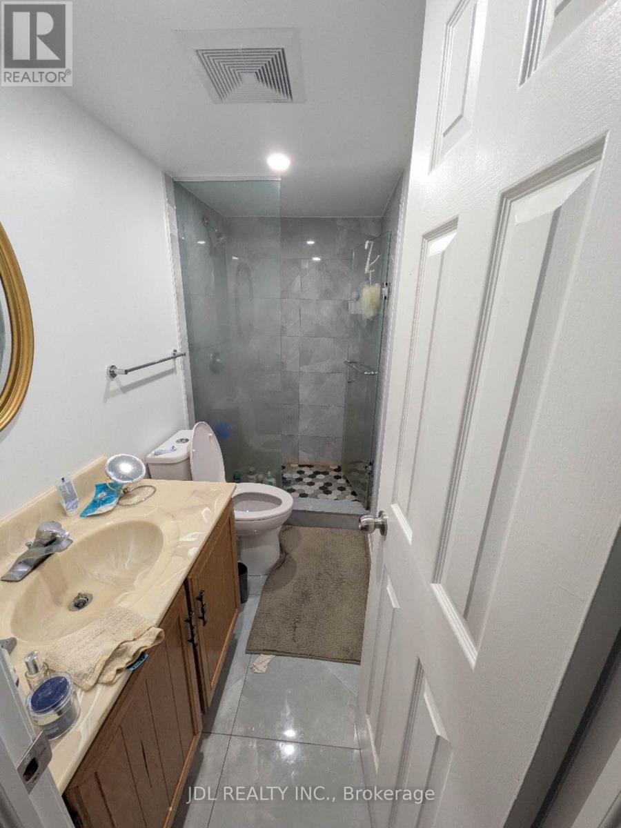 A bathroom with a sink, toilet, and shower.