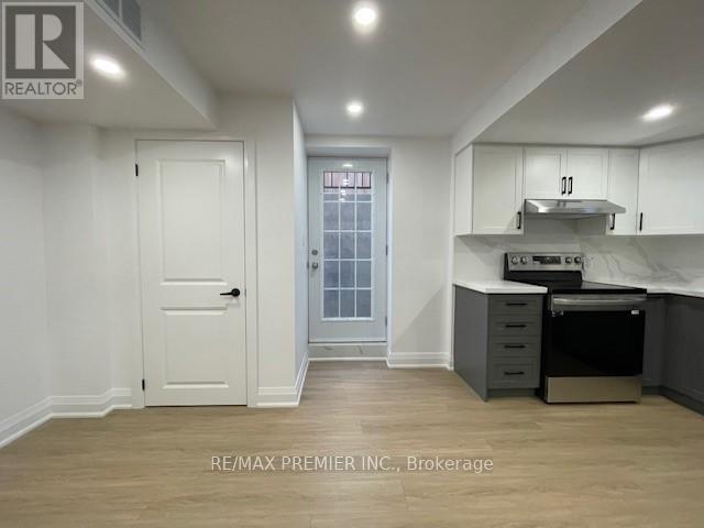 A kitchen area with a stove, oven, and cabinets.