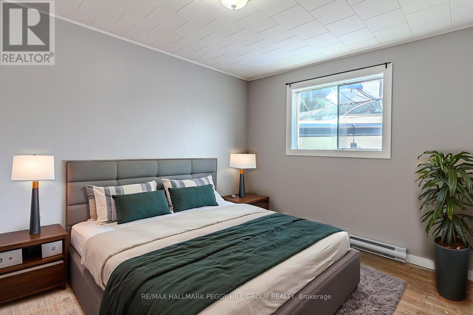 A bedroom with a large bed and a window.
