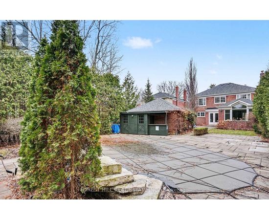 A large backyard with a pool and a house in the background.