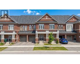 A two-story brick house with a garage is for sale.