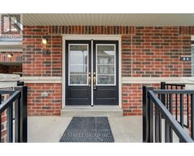 A black double door with a glass window is set in a brick wall.