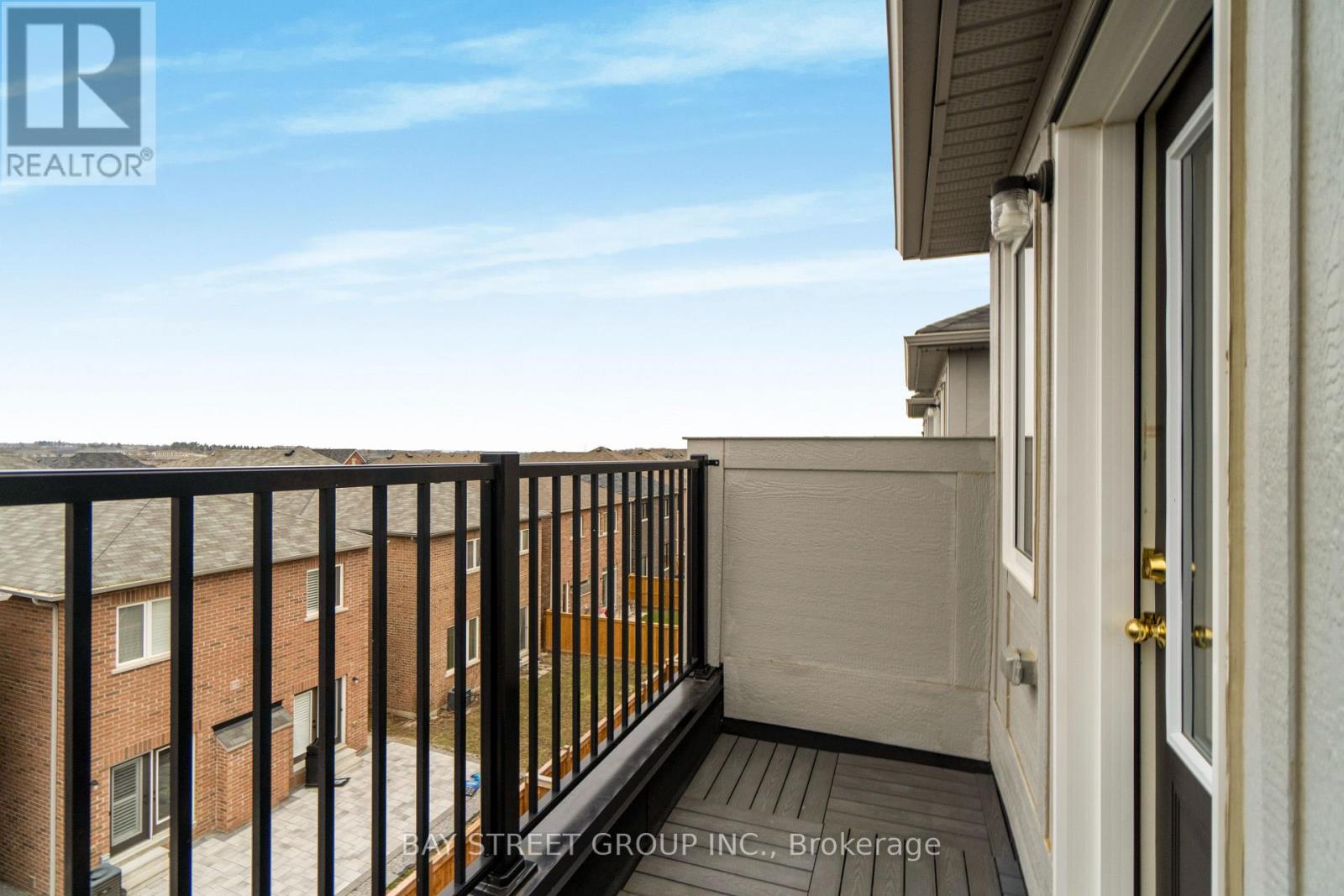 A balcony of a building with a view of other buildings.