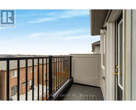 A balcony of a building with a view of other buildings.