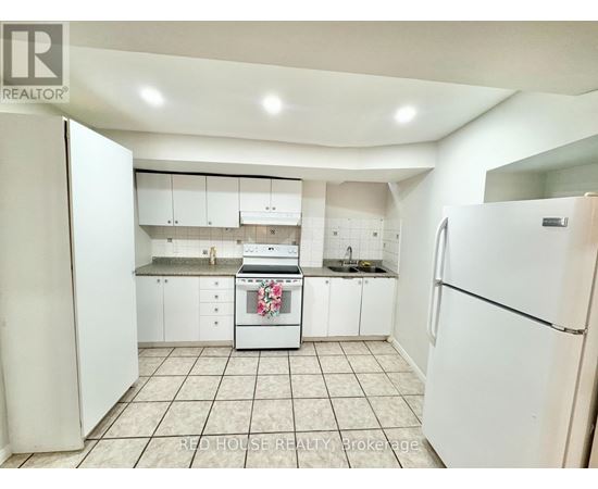 A kitchen with white appliances and cabinets.