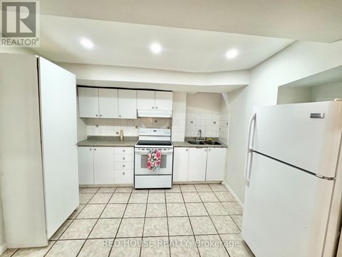 A kitchen with white appliances and cabinets.