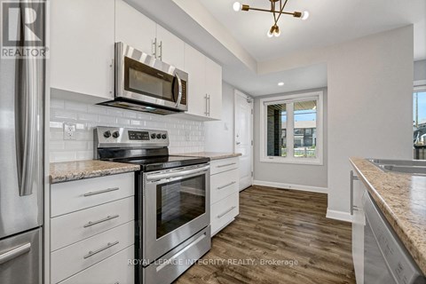 A kitchen with a stove top oven and microwave above it.