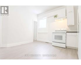 A white kitchen with EXP REALTY Brokerage written on the bottom.