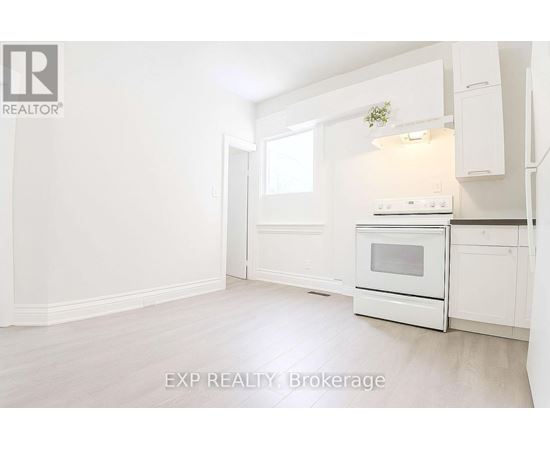 A white kitchen with EXP REALTY Brokerage written on the bottom.