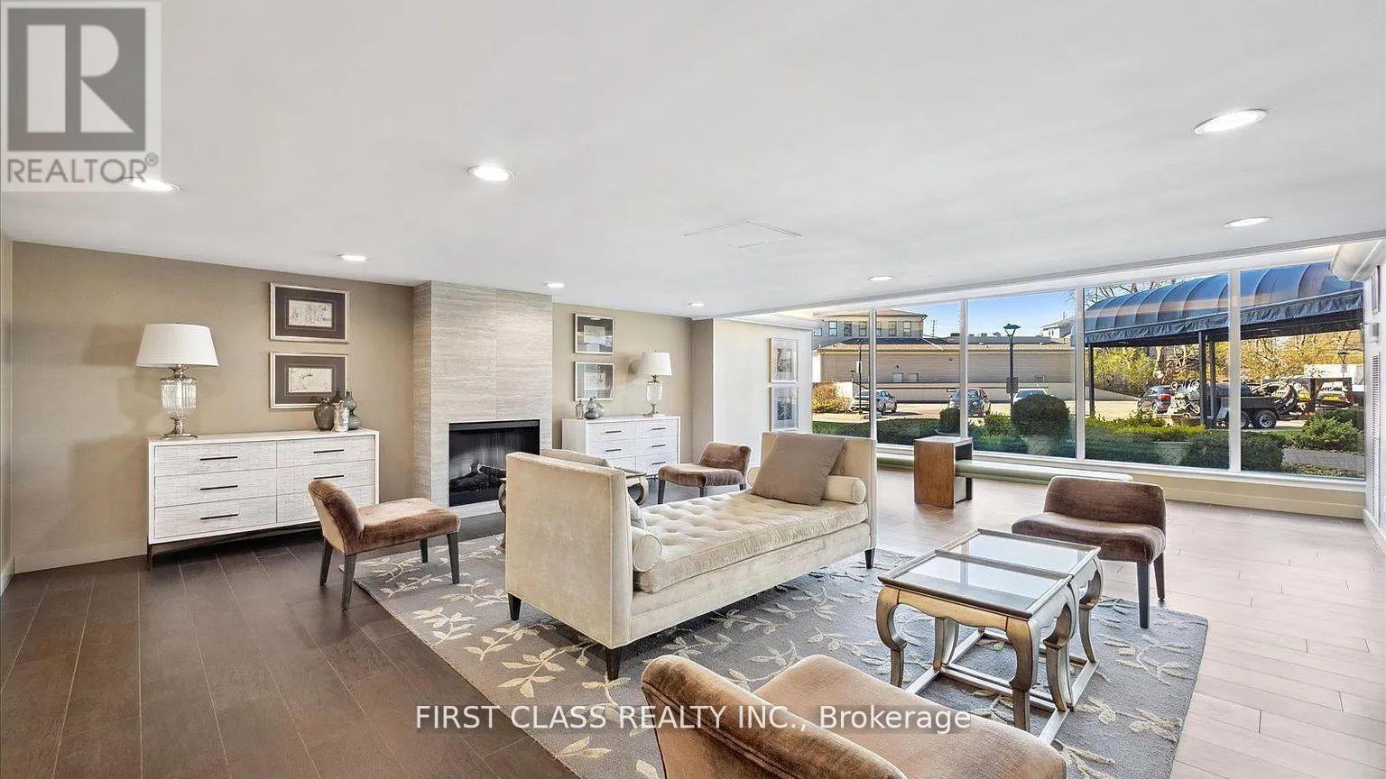 A well-lit living room with a fireplace and a large window.