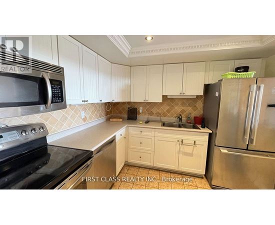 A kitchen with white cabinets and a black stove top oven.