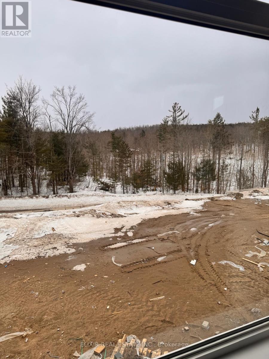 A muddy field with trees in the background.