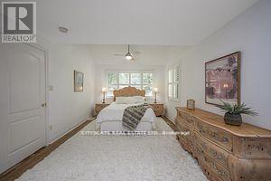 A bedroom with a large bed and a dresser.