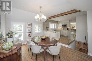 A dining room with a wooden table and chairs.