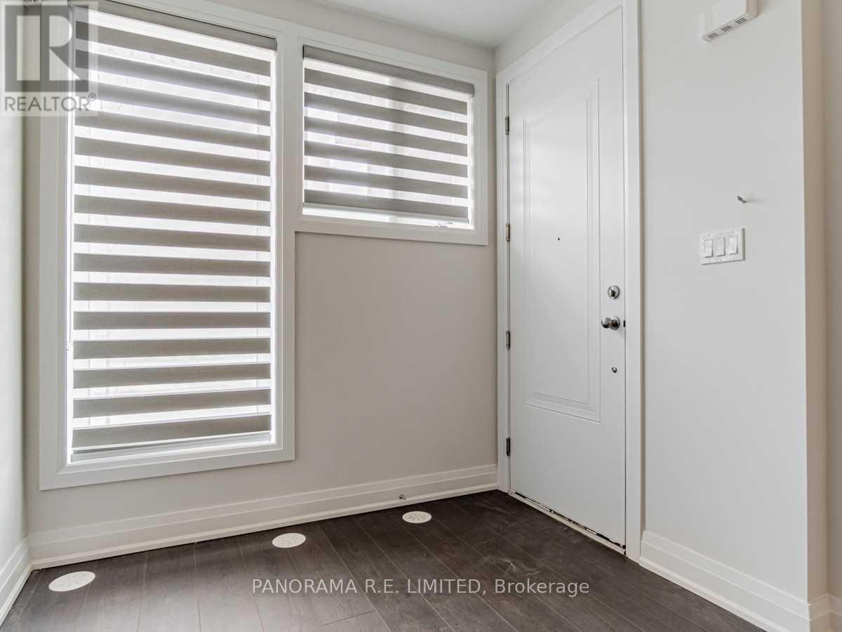A room with a door and a window with shutters.