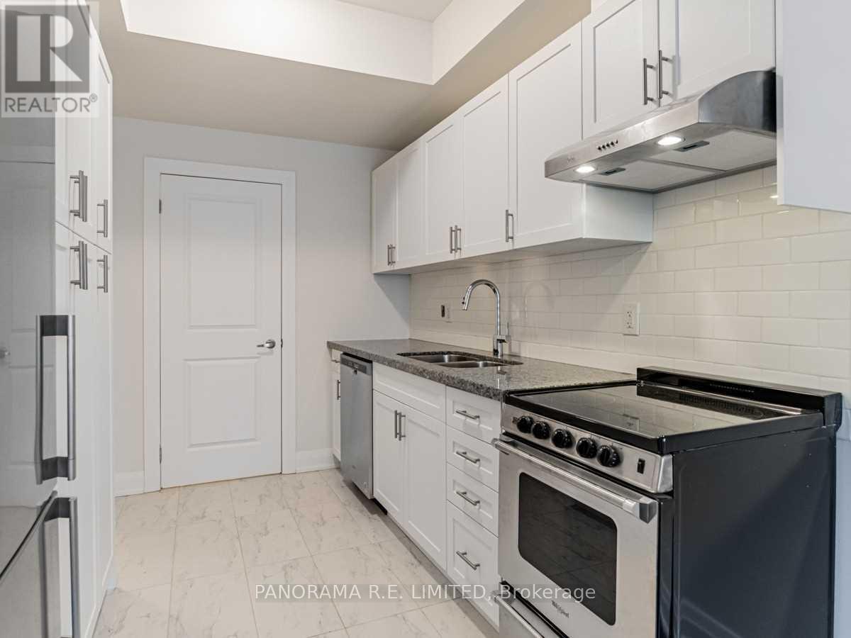 A kitchen with white cabinets and a black stove top oven.