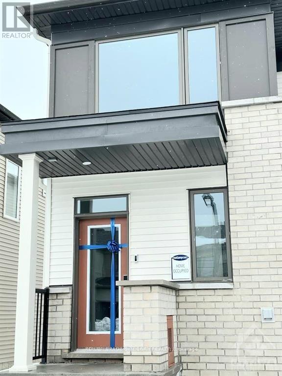 A house with a blue door and a sign that says "For Rent".